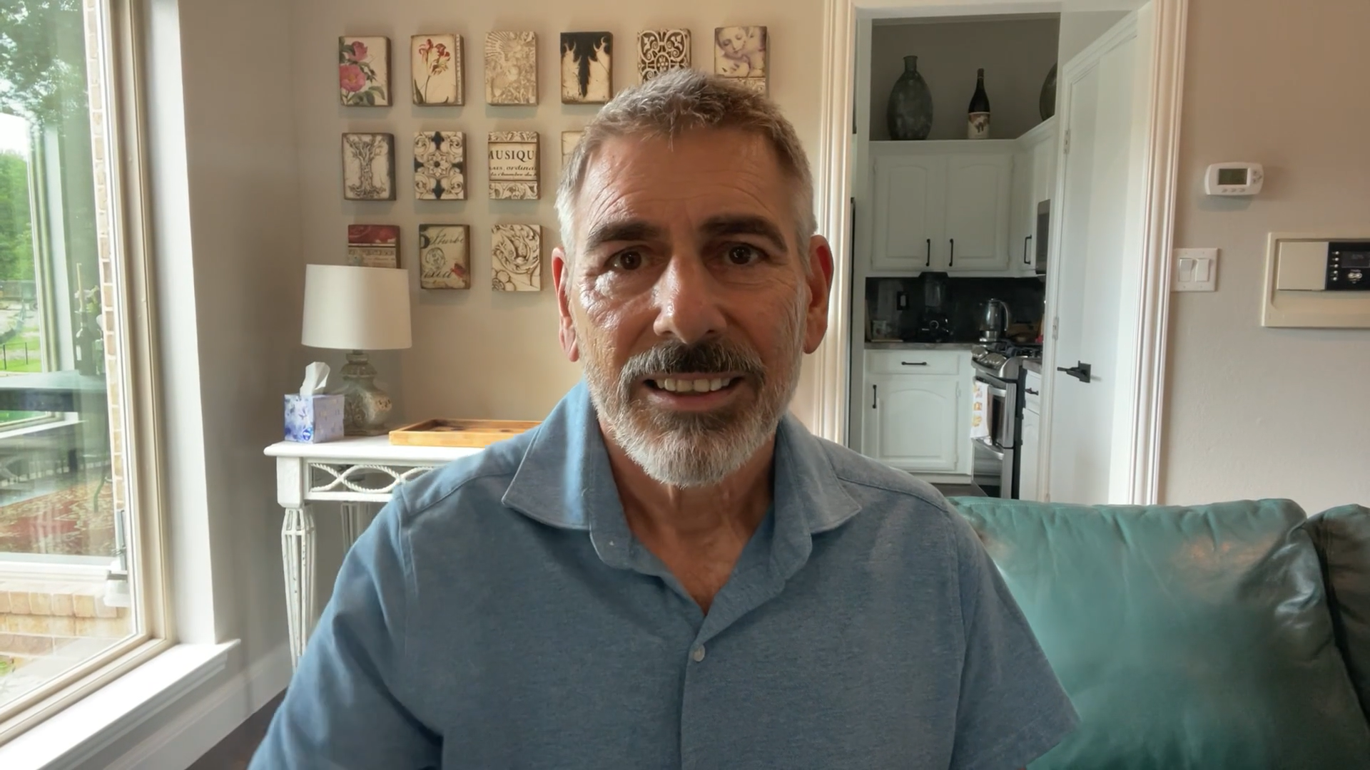 Middle-aged man smiling on living room couch