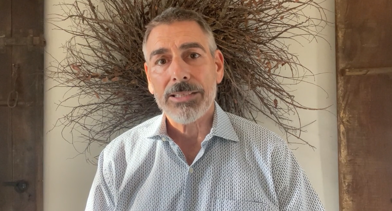 Bearded man in patterned shirt with twig wreath